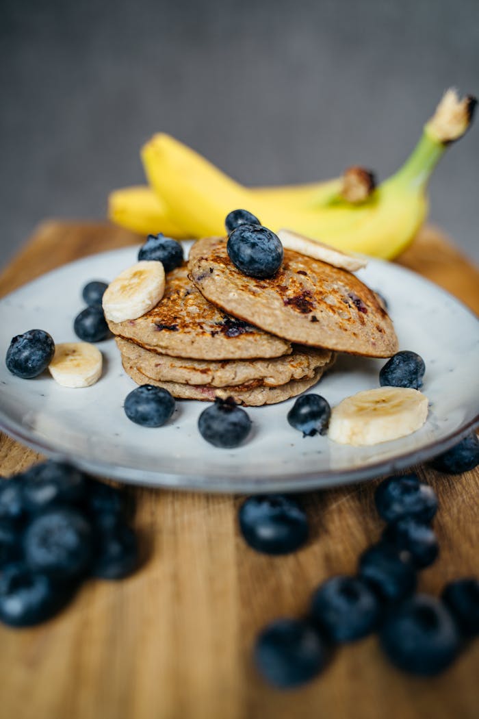 Banana and Blueberries on Stack of Pancakes
